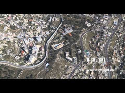 AJ4K 030  - Aerial 4K footage of Jerusalem: The separation wall in Abu Dis, east Jerusalem